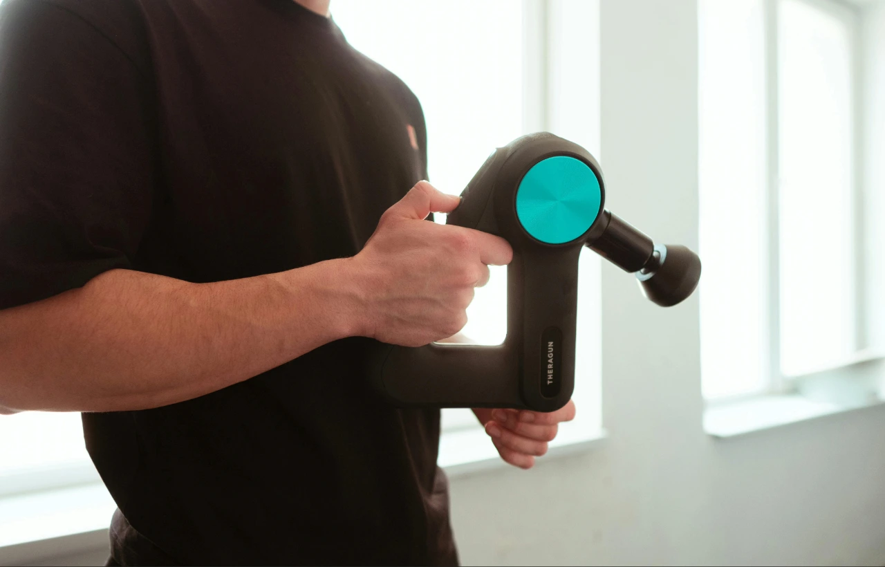 Man using a massage gun.