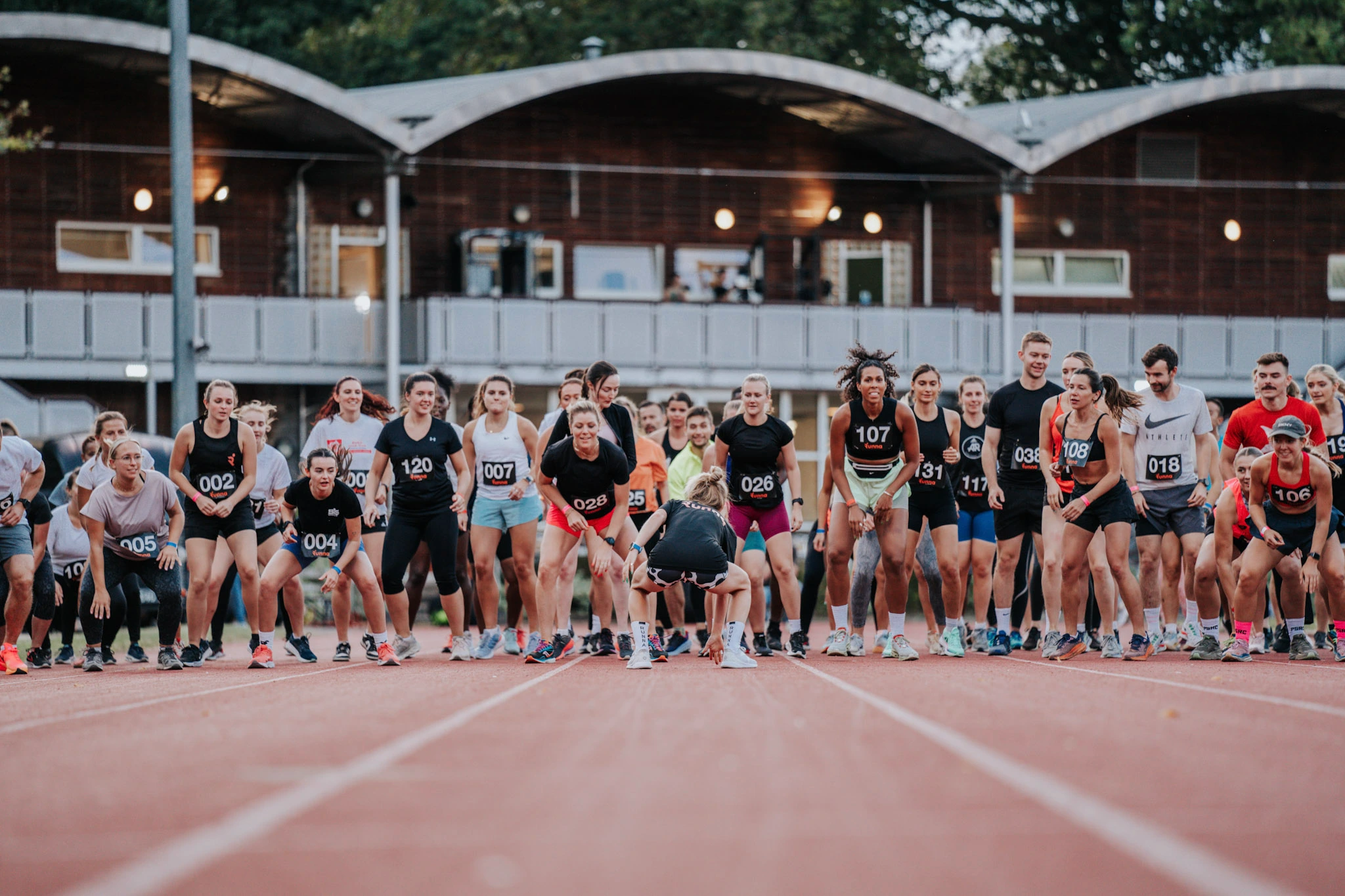 People lining up at a running track