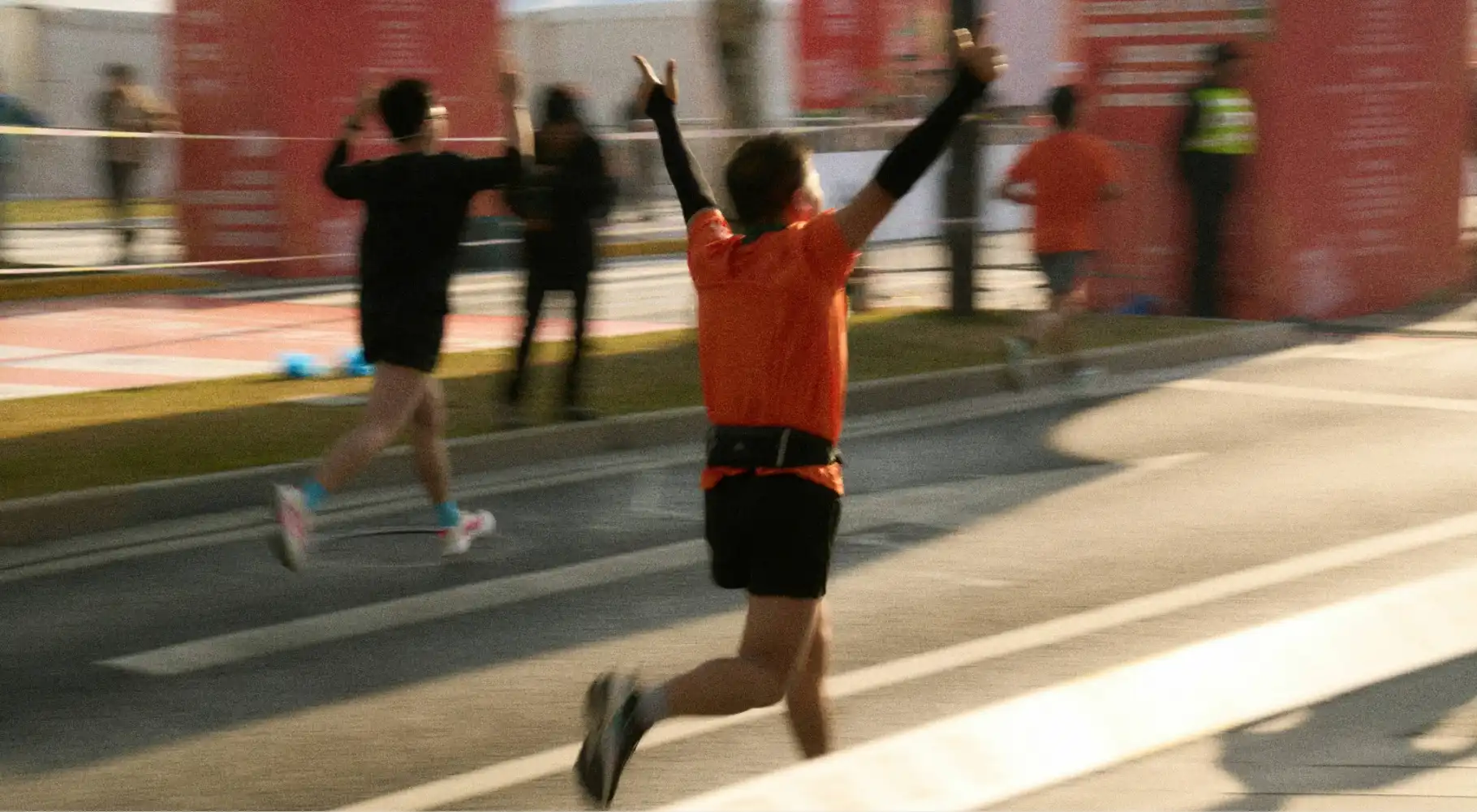 Man celebrating over the finish line. 