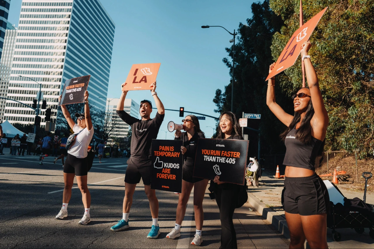 Runna team holding up signs 
