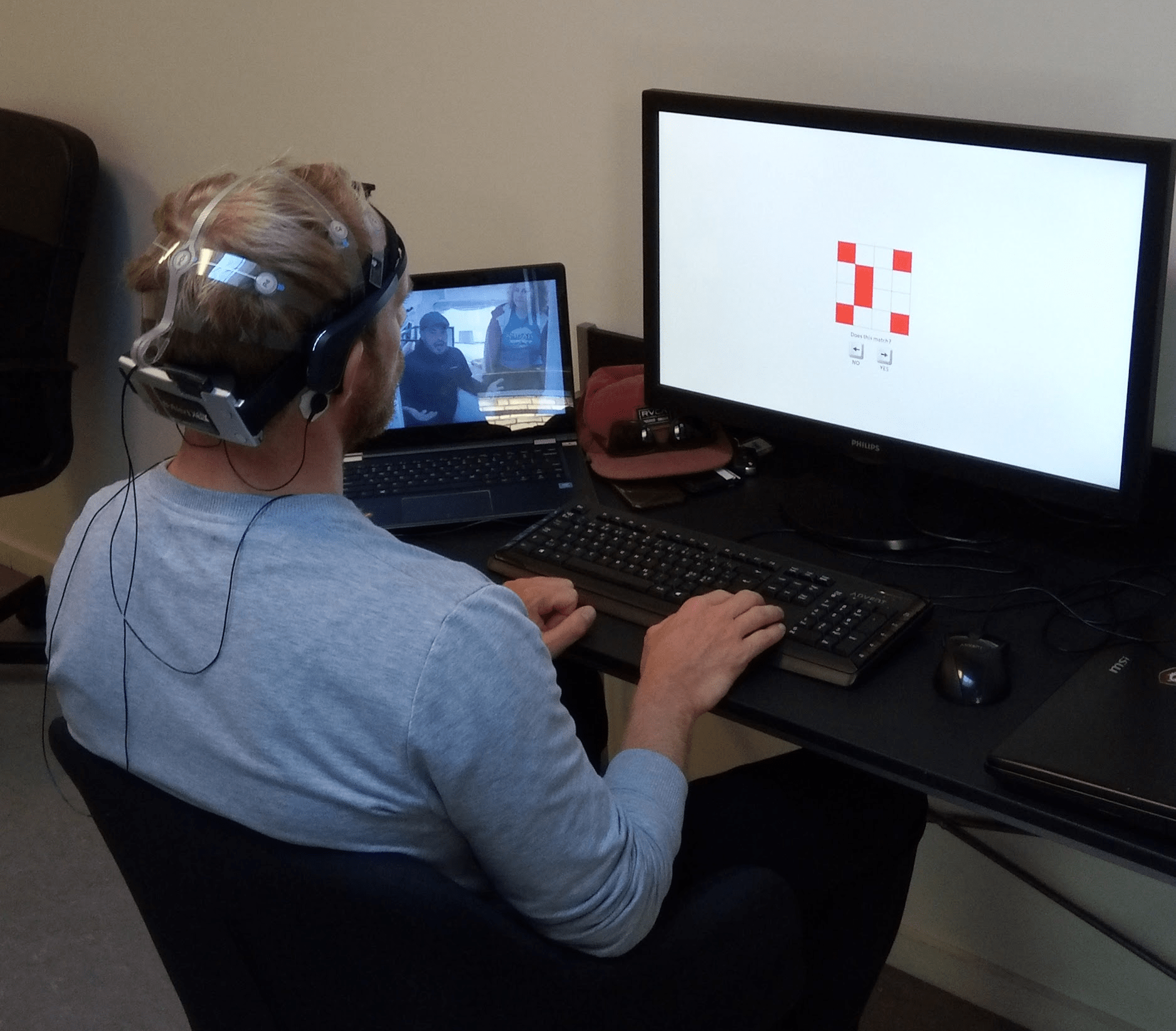 Man seated with EEG headset.