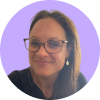 Smiling woman wearing glasses and earrings with a light purple circular background.