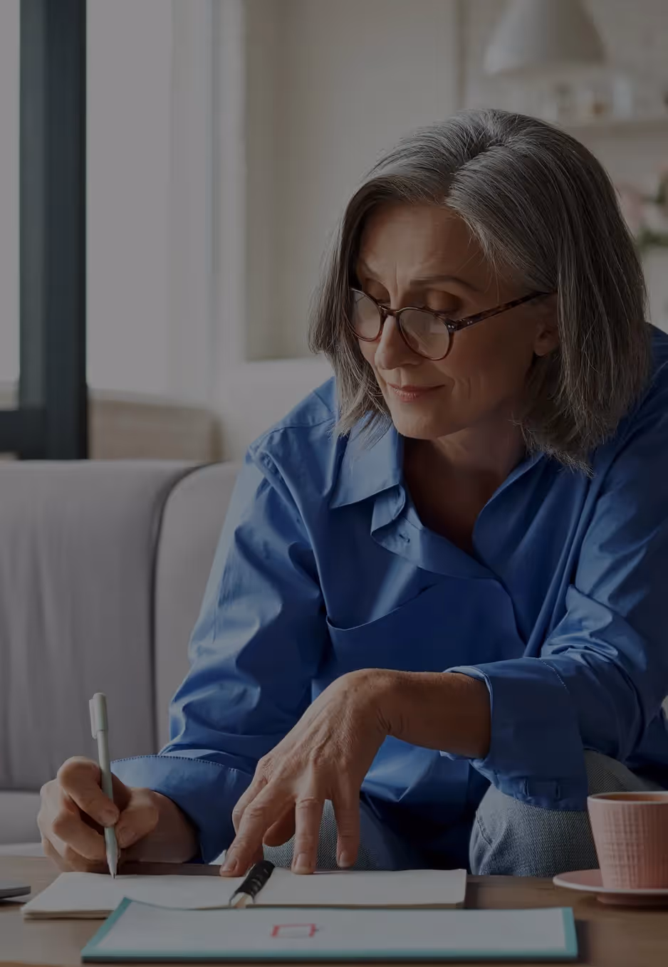 woman signing a document.