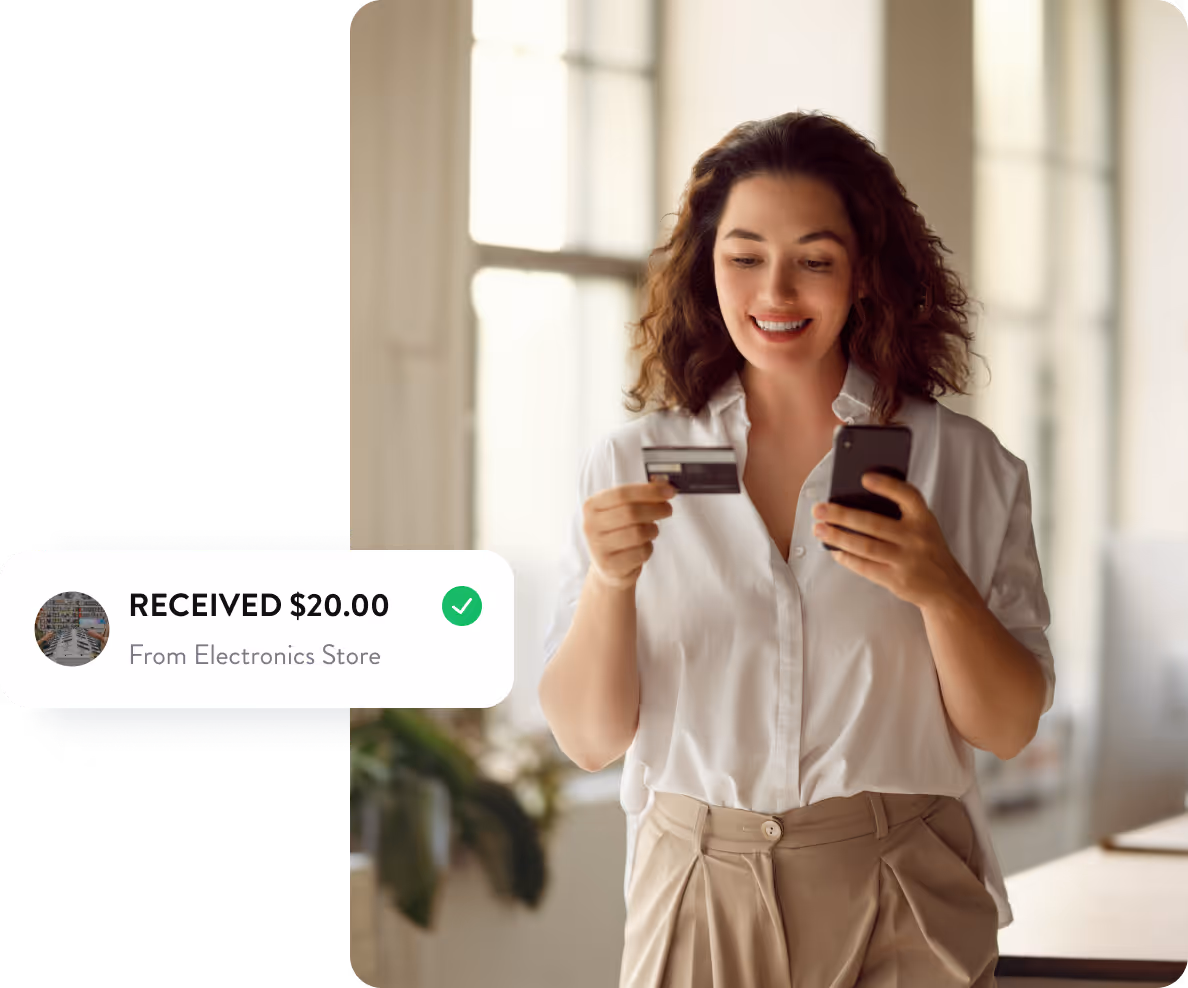 woman holding credit card and phone.