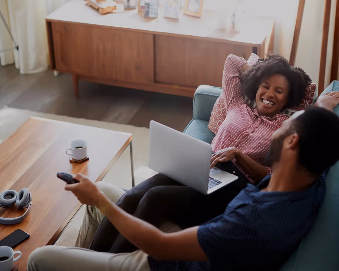 couple laying on a couch.