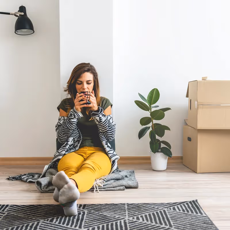 woman sitting on the floor using phone.