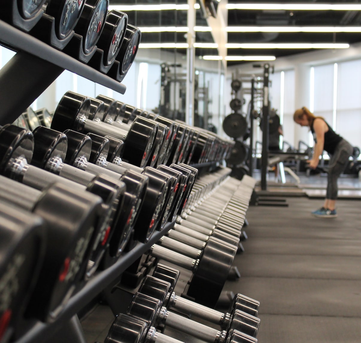Weights and a woman training.