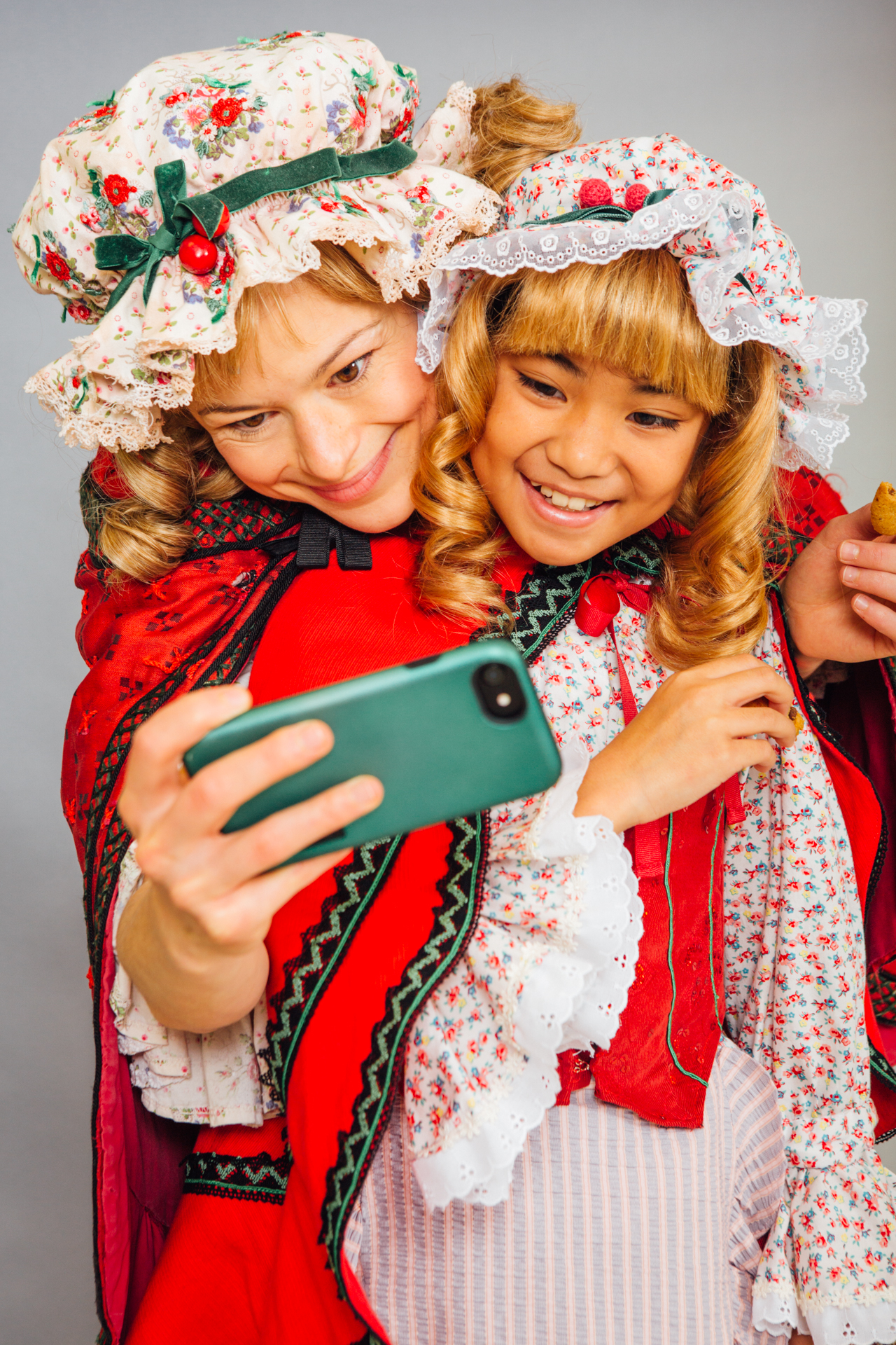Portrait of a child and adult dressed up as the same character taking a selfie as a portrait photograph