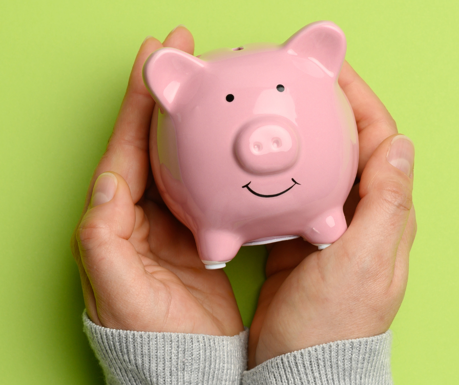 Two hands holding a piggy bank