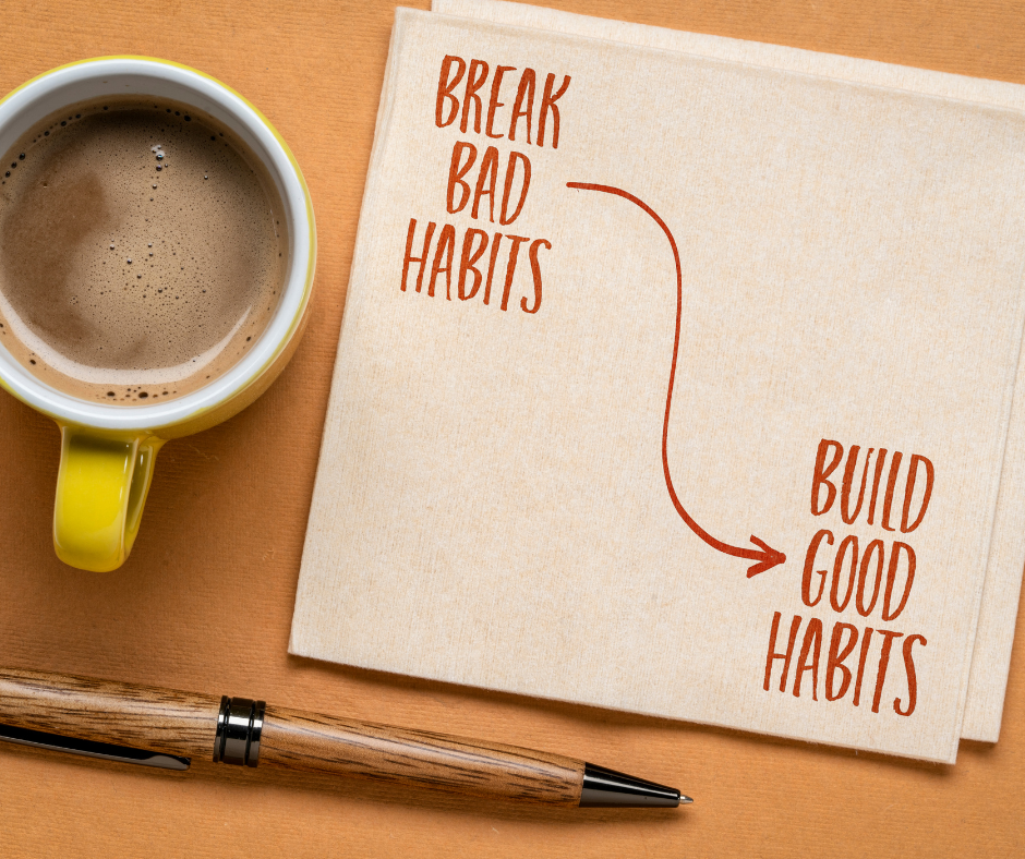 A coffee and napkin with the words break bad habits, buid good habits and an arrow connecting them