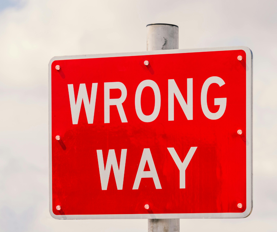 Red wrong way sign with the writing in block white letters