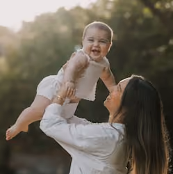 Mom holding up newborn baby
