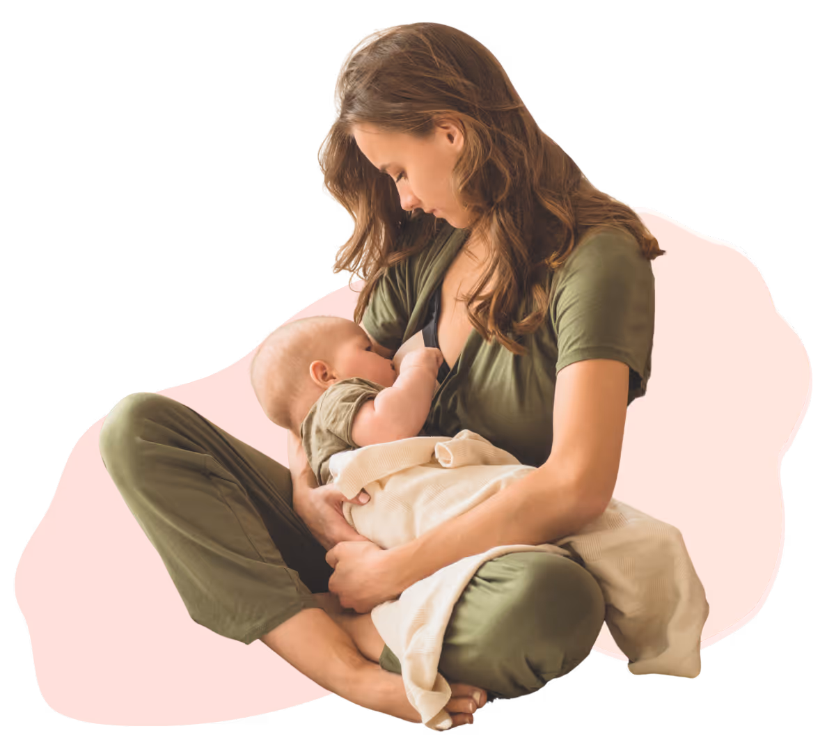 Mother breastfeeding baby while sitting cross-legged, both wearing green clothing.