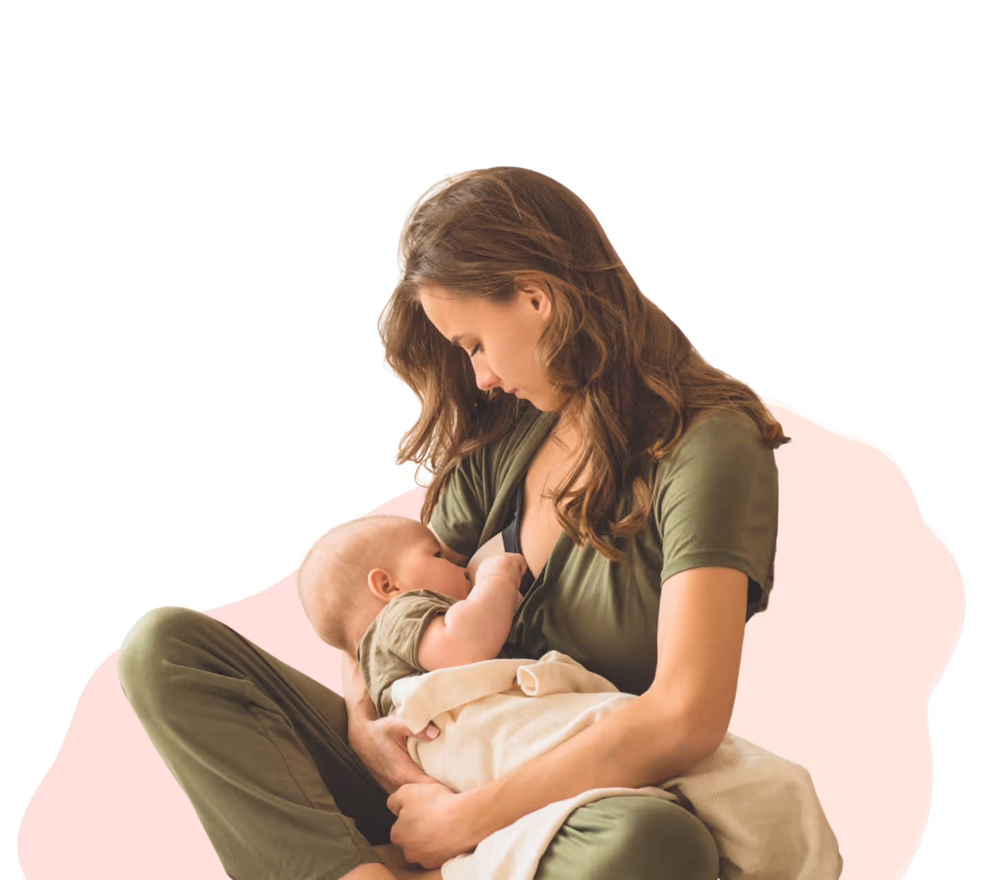 Mother breastfeeding infant while seated, both wearing green clothing and the baby covered with a beige blanket.