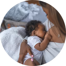 Pregnant mom with phone on belly reading message about getting started with lactation and postpartum support