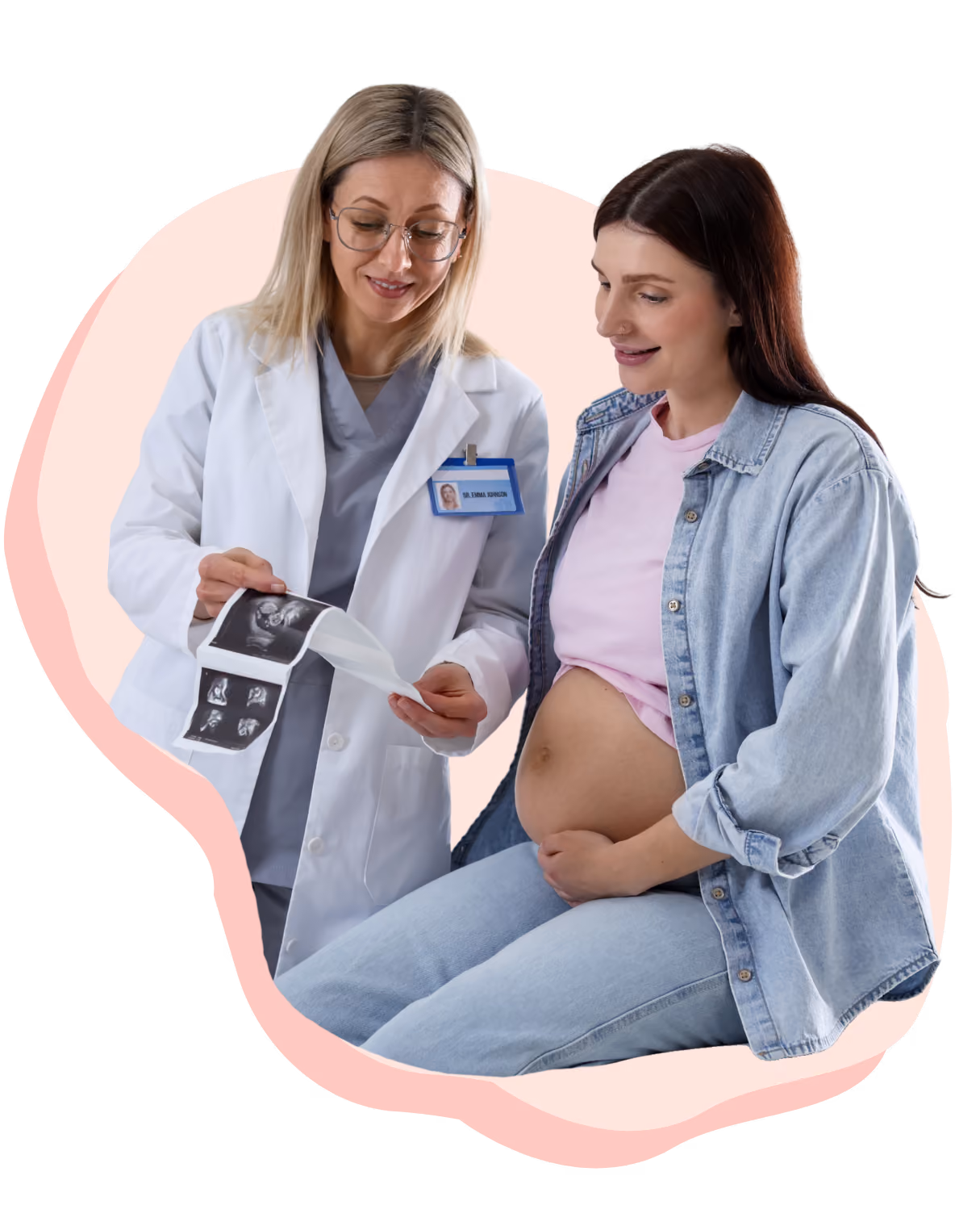 A female doctor in a white coat showing ultrasound images to a pregnant woman who is seated and holding her exposed belly, both smiling.