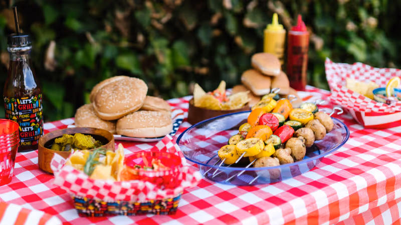 A picnic table full of food.