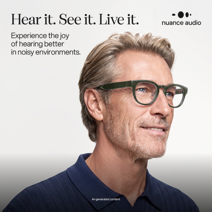 Person wearing blue Nuance Audio hearing glasses designed to support hearing in noisy environments
