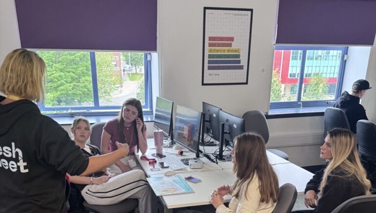 Young people working through a challenge brief with a Fresh Meet facilitator during a Careers in Digital workshop session.