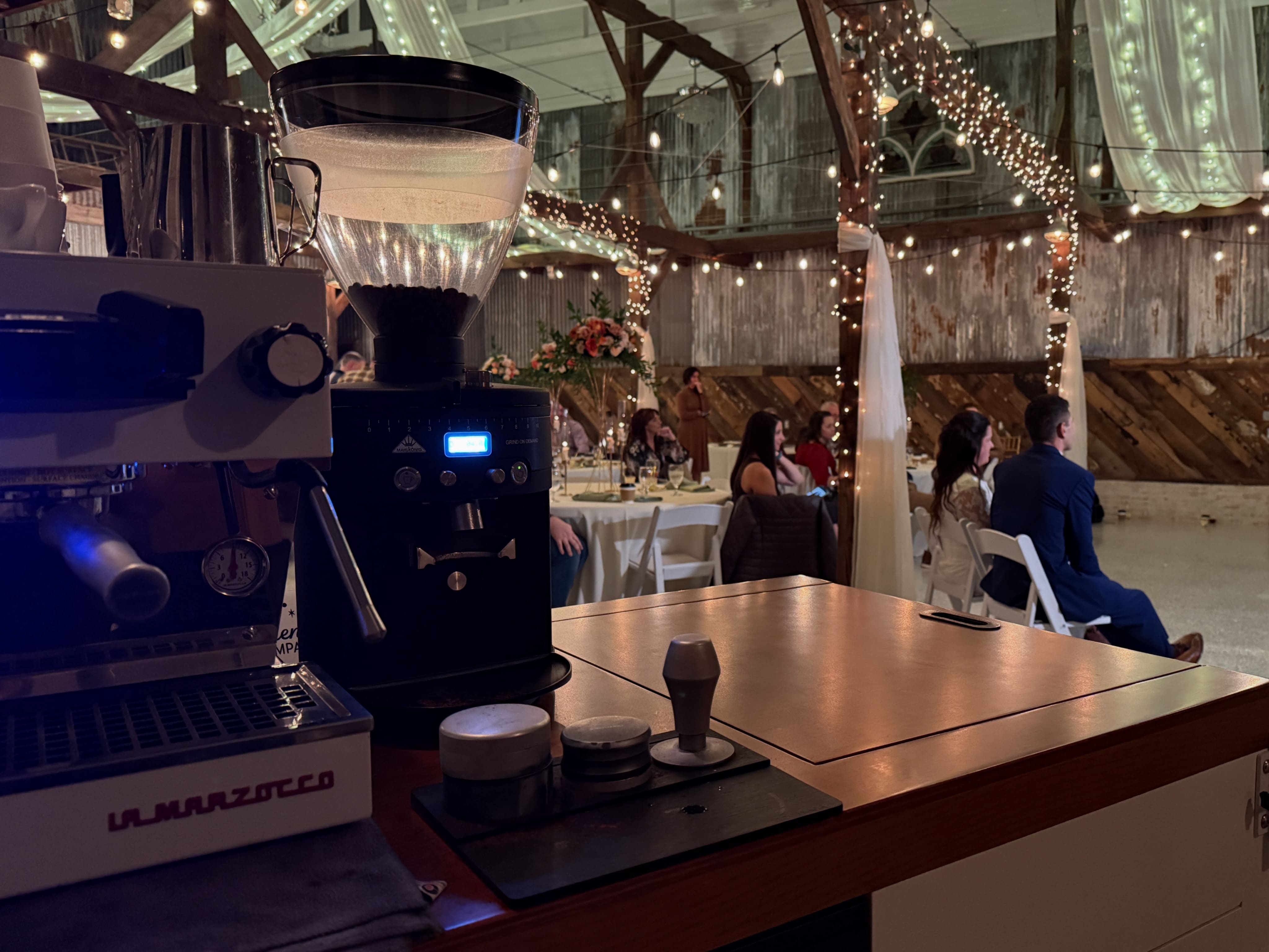Espresso bar setup by Best Friend Coffee Co. at a rustic barn wedding in West Virginia, offering on-site coffee catering with a La Marzocco machine.