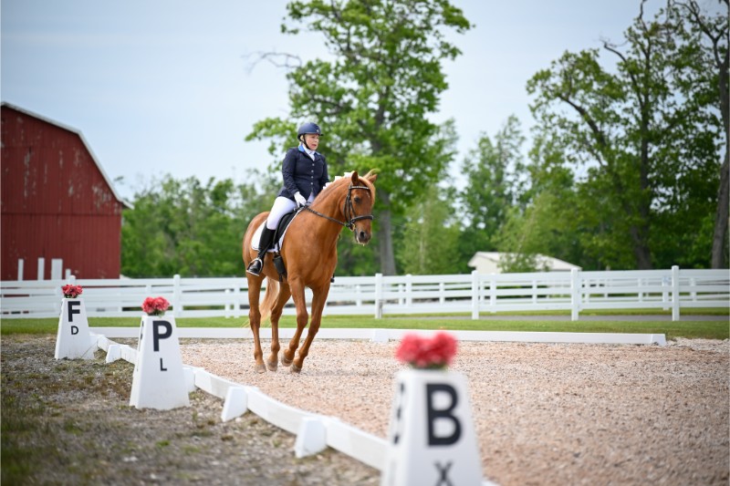 a woman rides a horse