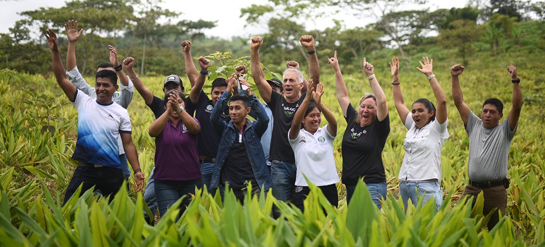 Excited Frontier employees and farmers in a turmeric field