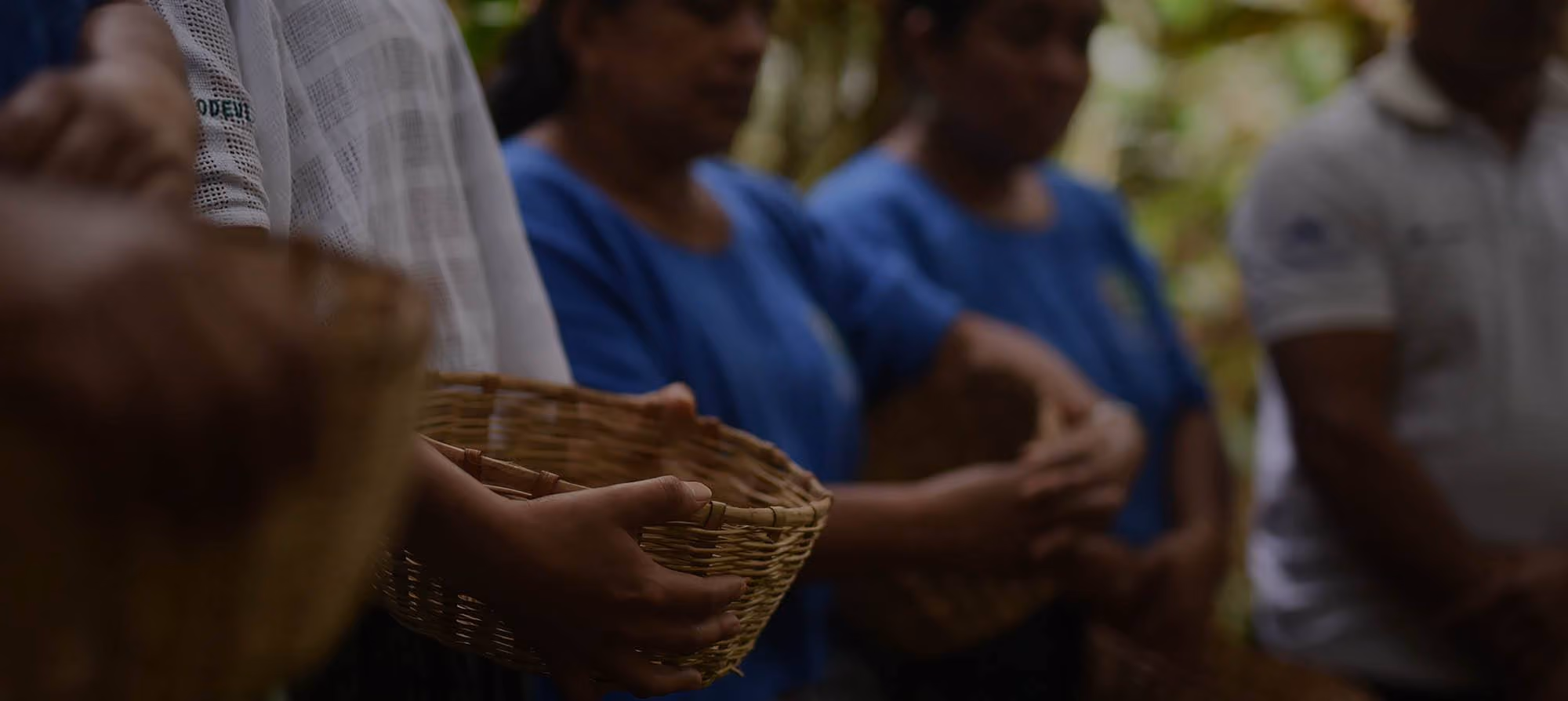 Cardamom farmers holding baskets