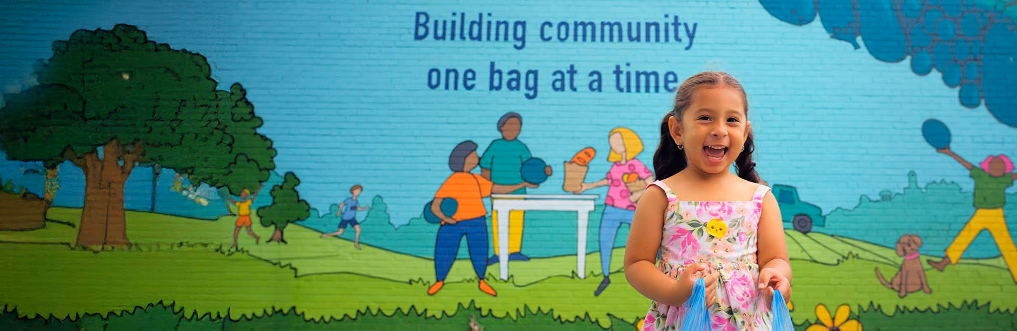 A child standing in front of a mural