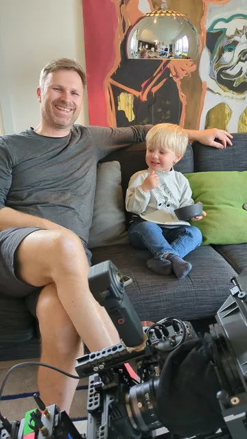 Liten skuespiller (2 år), har matpause sammen med fotograf (48 år) behind the scenes fra reklamefilminnspilling for 24Nettbutikk.