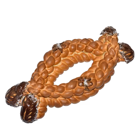Braided bread shaped in an oval with four small brown decorations attached on the top and ends.