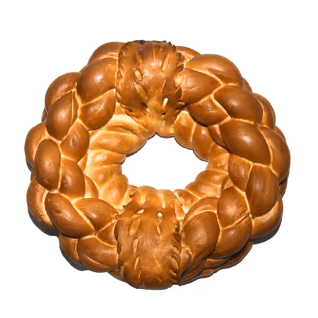 Golden braided bread shaped into a round wreath with an open center.
