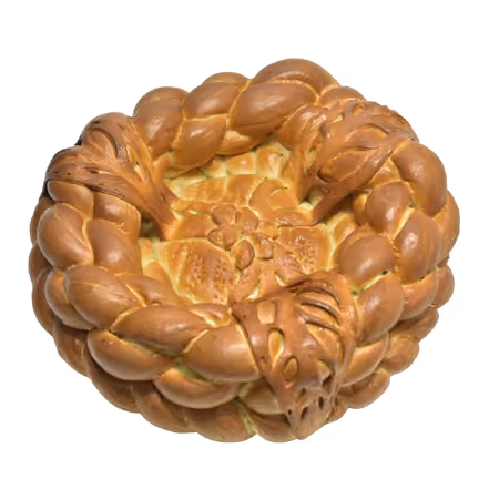 Decorative braided bread wreath with intricate leaf and flower patterns.