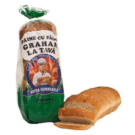 Package of sliced Graham wheat bread with a loaf of partially sliced bread next to it.