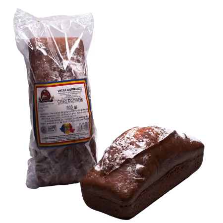 Packaged and unpackaged chocolate cake loaf dusted with powdered sugar.