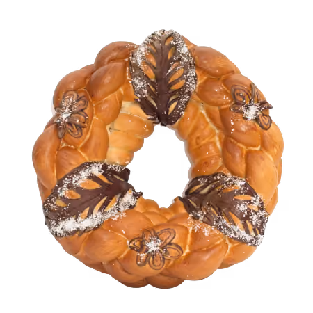 Round braided bread decorated with dark brown leaf and flower shapes, dusted with powdered sugar.