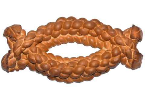 Braided loaf of bread shaped in an elongated oval with ends tied together.