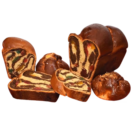 Assorted sliced fruit and chocolate swirl bread loaves with two round bread rolls.