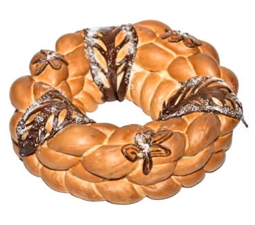 Round braided bread wreath decorated with floral patterns and dark chocolate accents.