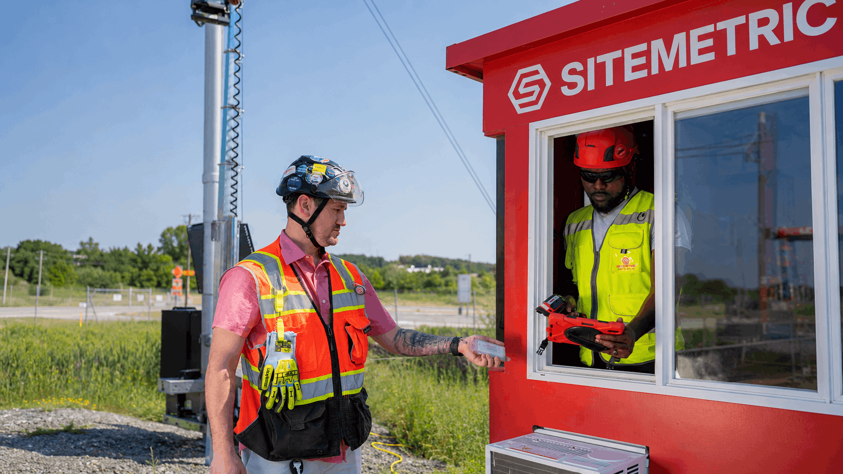 Access Control Officer scanning a worker badge at a construction site access control booth
