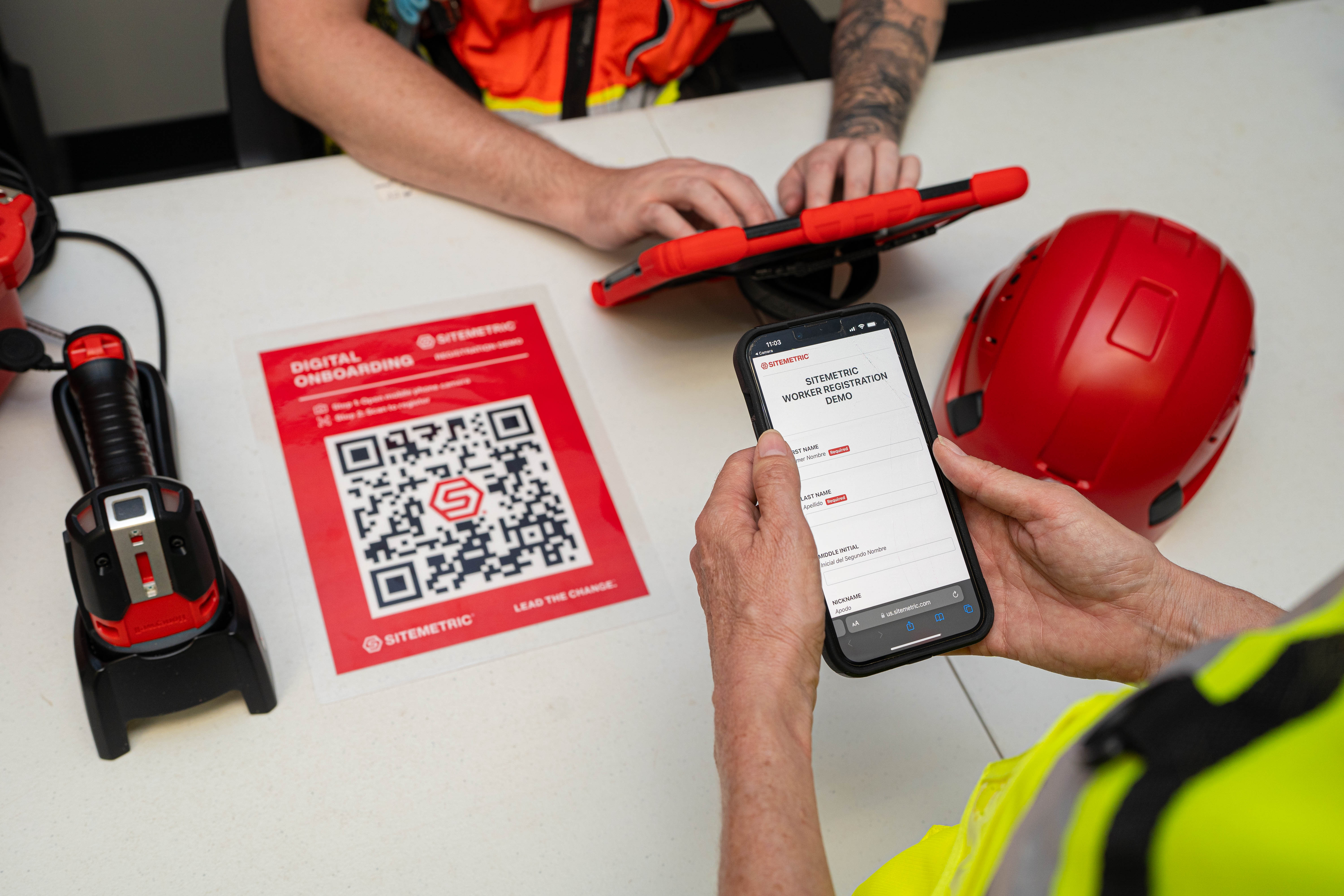 Construction worker completing digital onboarding at a jobsite enrollment station