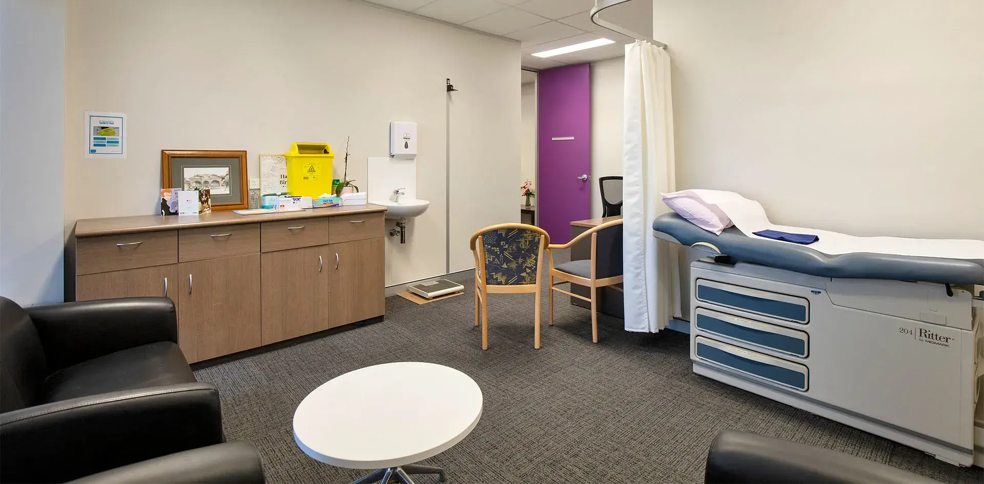 Inside Doctor's room with cupboard, lounge, bed and chairs