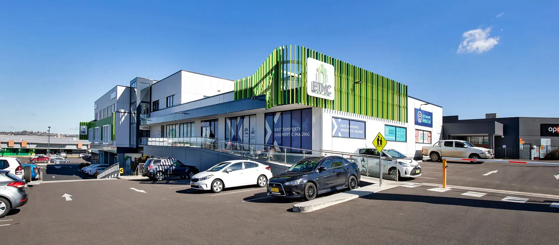 Outside of Doctor's Surgery building with cars out front and purple overlay