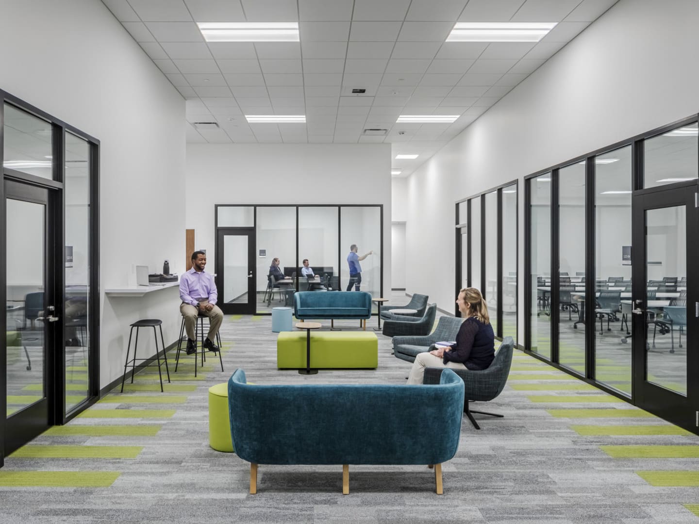 An interior photo of a meeting lounge surrounded by conference rooms.