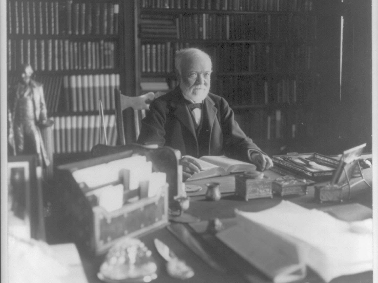 A photo of Andrew Carnegie in a reading room.