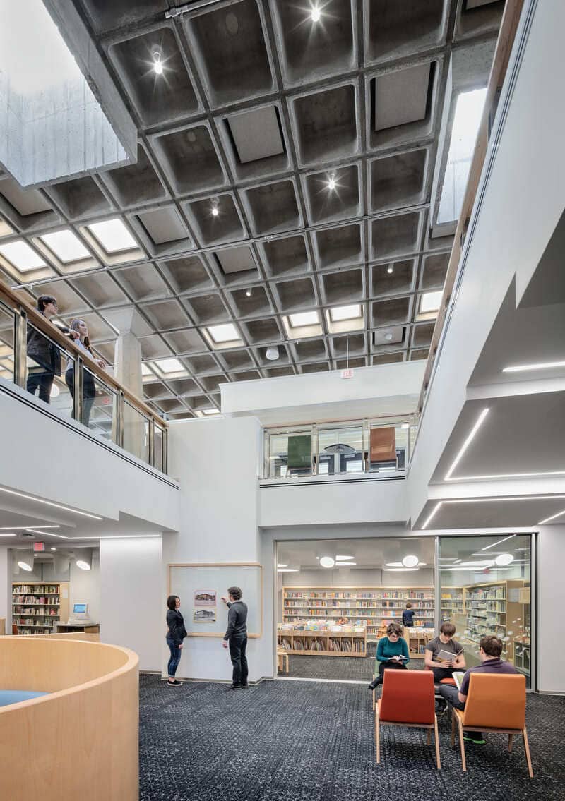 A photo of where the rooms all intersect, an area which contains an interesting ceiling design that has a concrete grid-like appearance.
