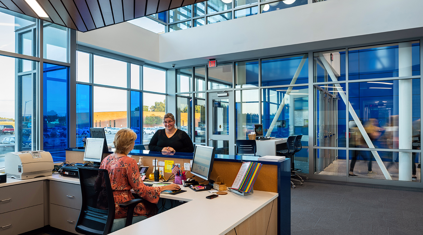 A photo of administrators at their new entry way desk.