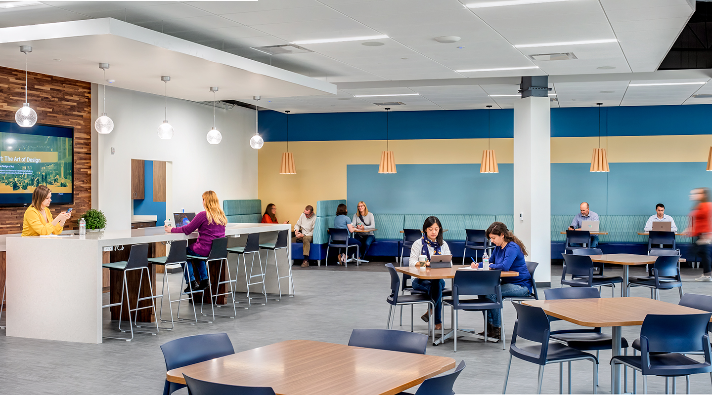 A photo of office workers at dining tables.