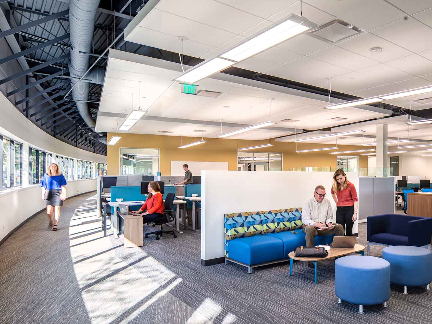 A photo of office workers utilizing open office space.