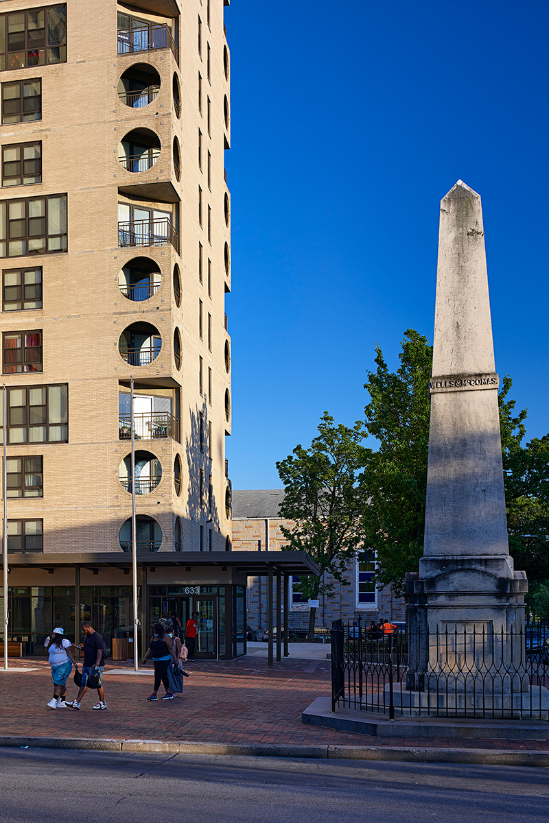 A photo of people outside an apartment building.