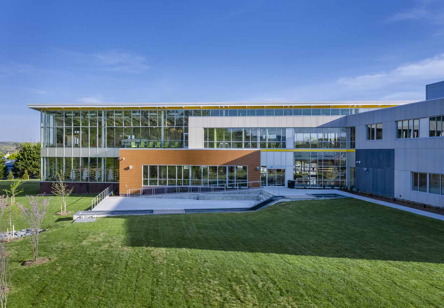 A photo of the building exterior that is lined with many glass windows.